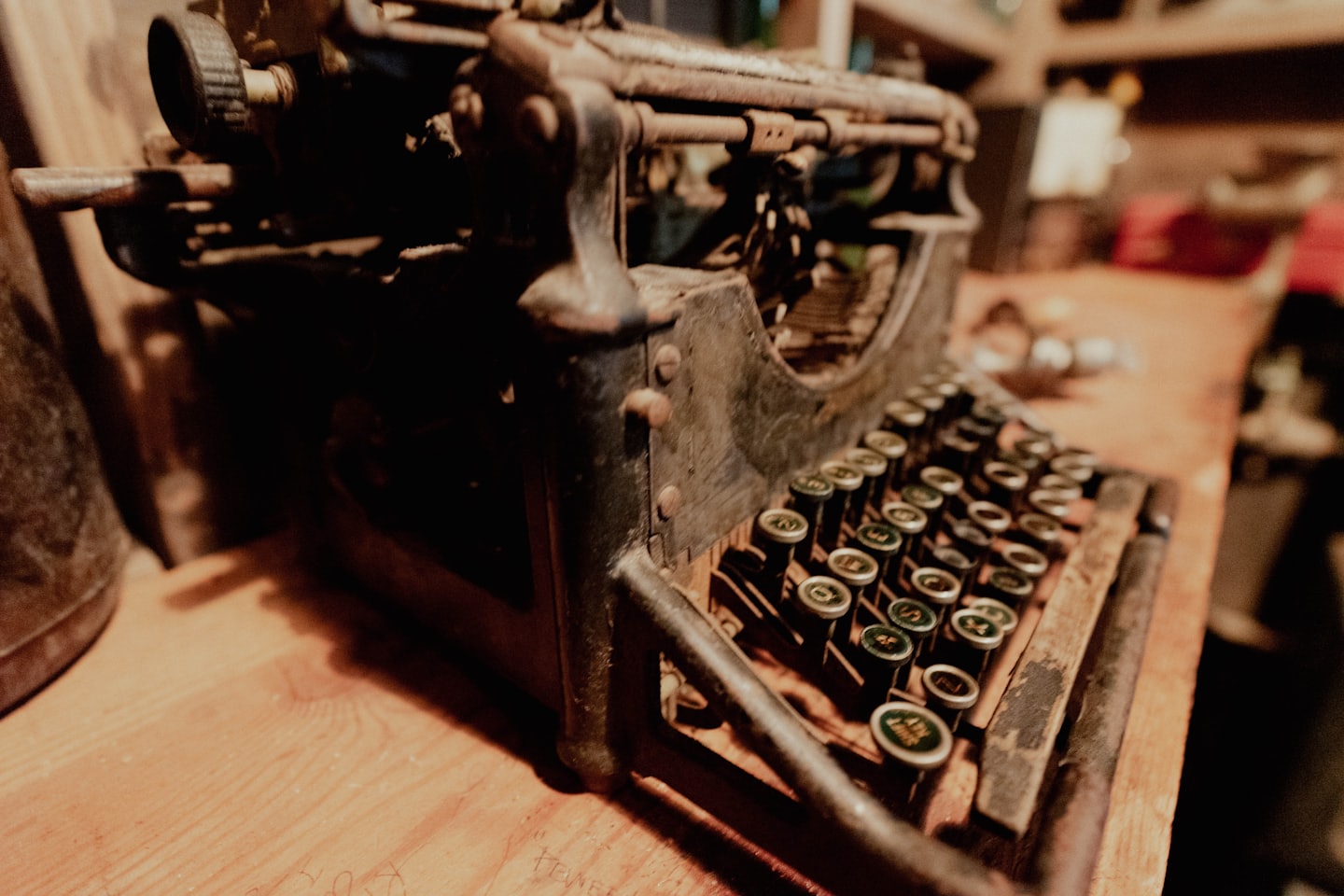 Antique typewriter on a wooden desk with round keys.